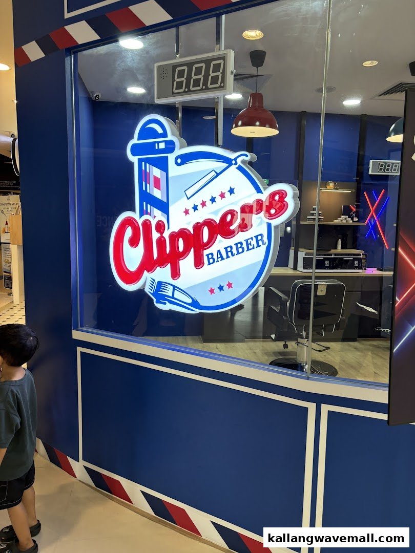 The vibrant blue and red storefront of Clippers Barber, featuring its distinctive logo.