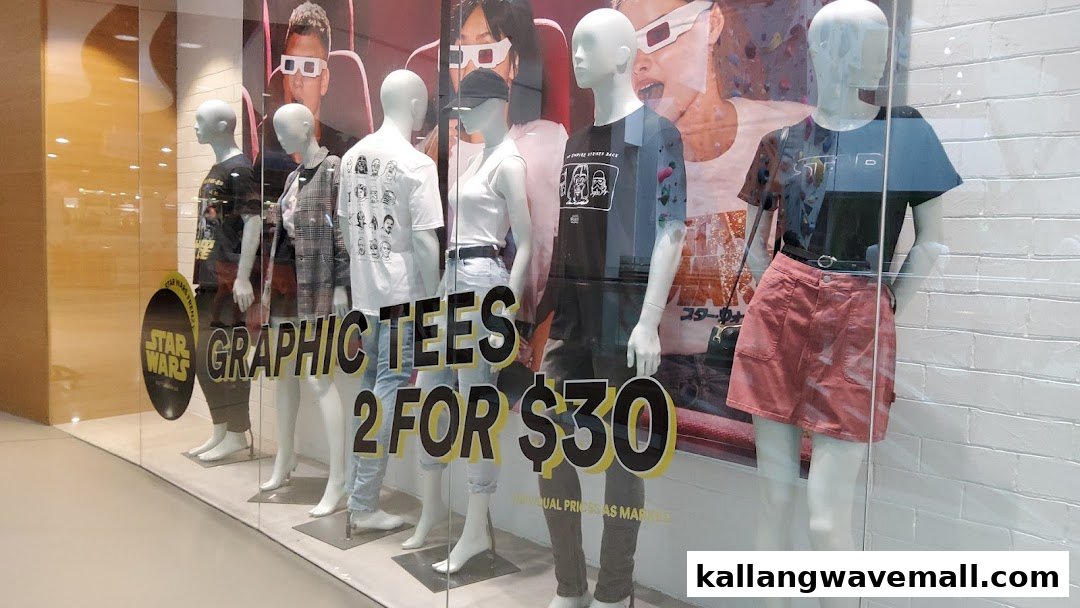 Mannequins in a shop window display graphic tees, including Star Wars designs, with a '2 FOR $30' promotion.