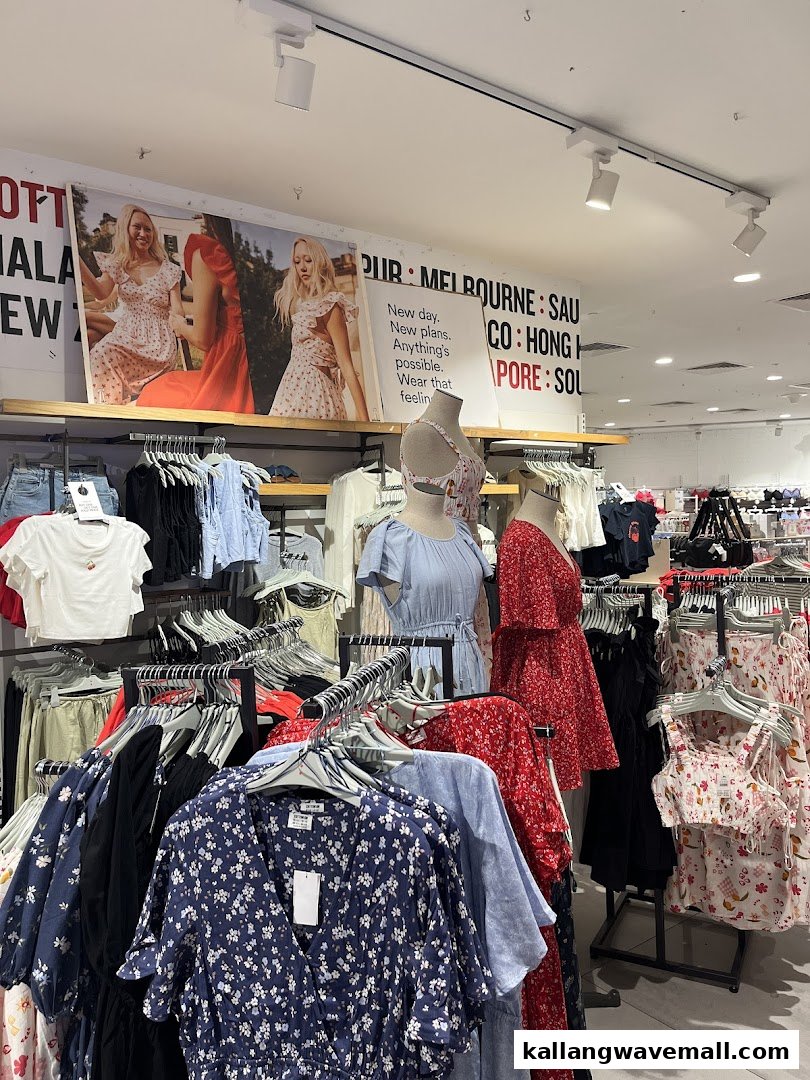 An interior view of Cotton On Sports Hub, showcasing a vibrant collection of women's apparel on racks and mannequins.