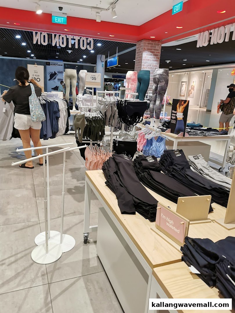 Interior view of Cotton On Sports Hub, showcasing activewear displays, mannequins, and a customer browsing apparel.