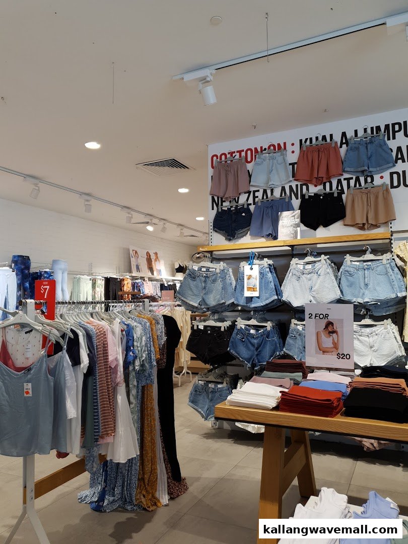 An interior view of Cotton On Sports Hub, showcasing racks of women's clothing, including shorts, tops, and dresses.