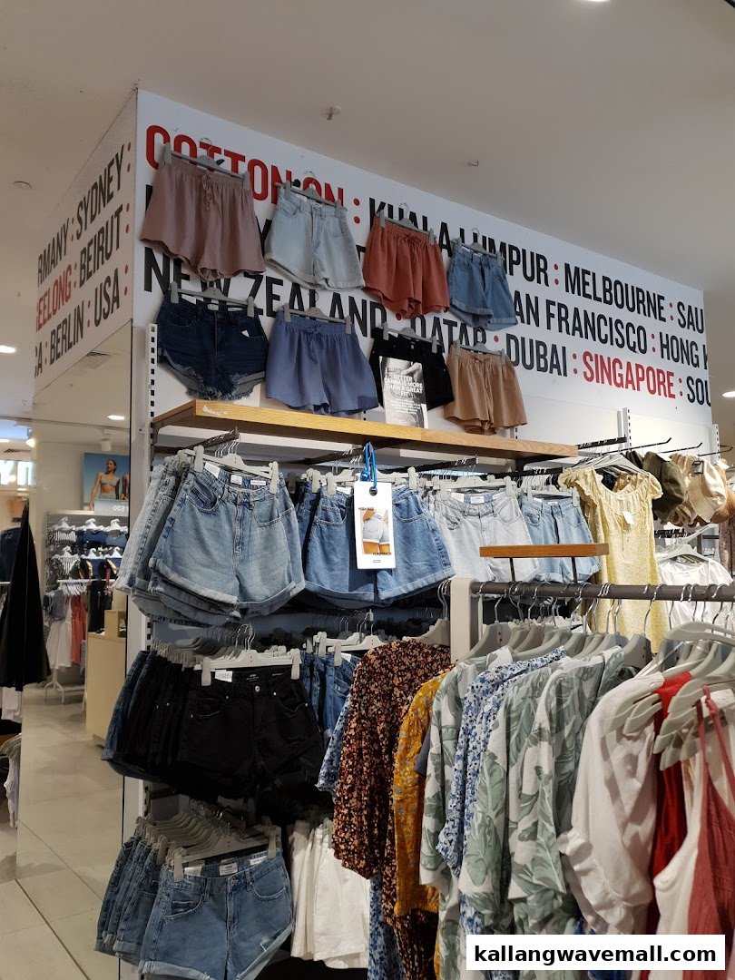 An interior view of Cotton On Sports Hub, showcasing a vibrant display of shorts and casual apparel.