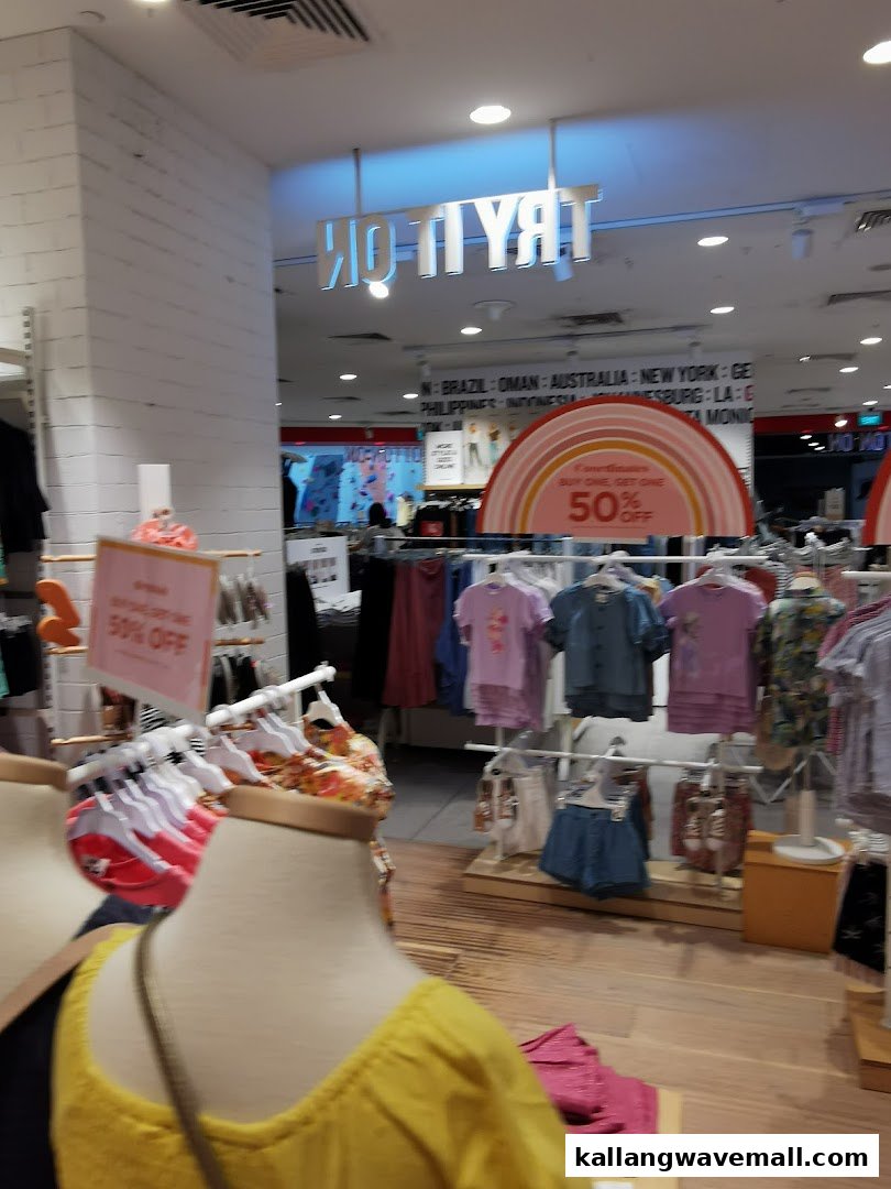 Interior view of Cotton On Sports Hub, showcasing clothing racks, mannequins, and promotional offers.