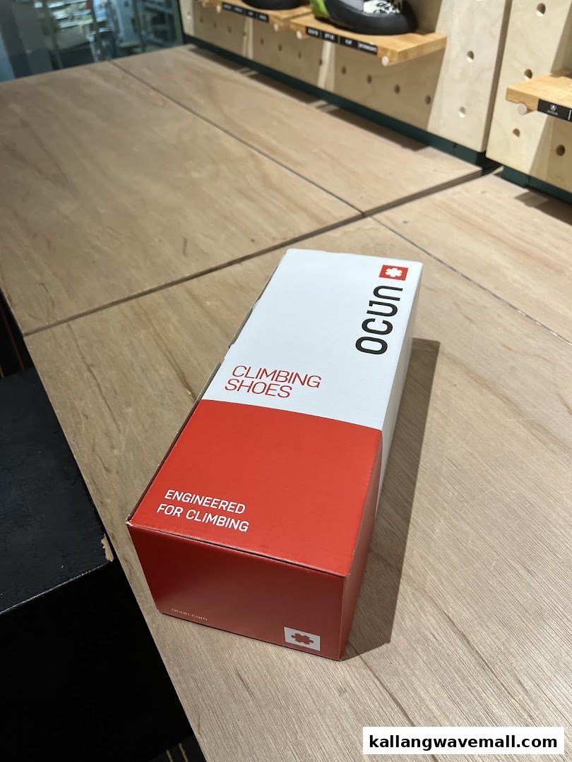 A box of Ocun climbing shoes on a wooden counter inside Crank Factory by Climb Asia.