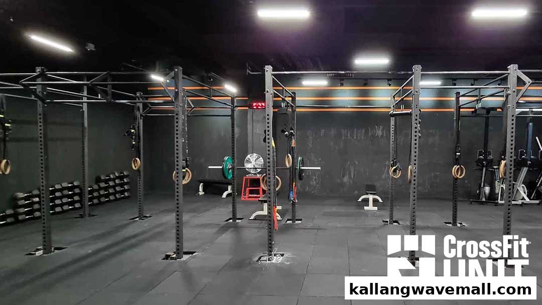 An interior view of CrossFit Unit, showcasing various gym equipment and a spacious workout area.