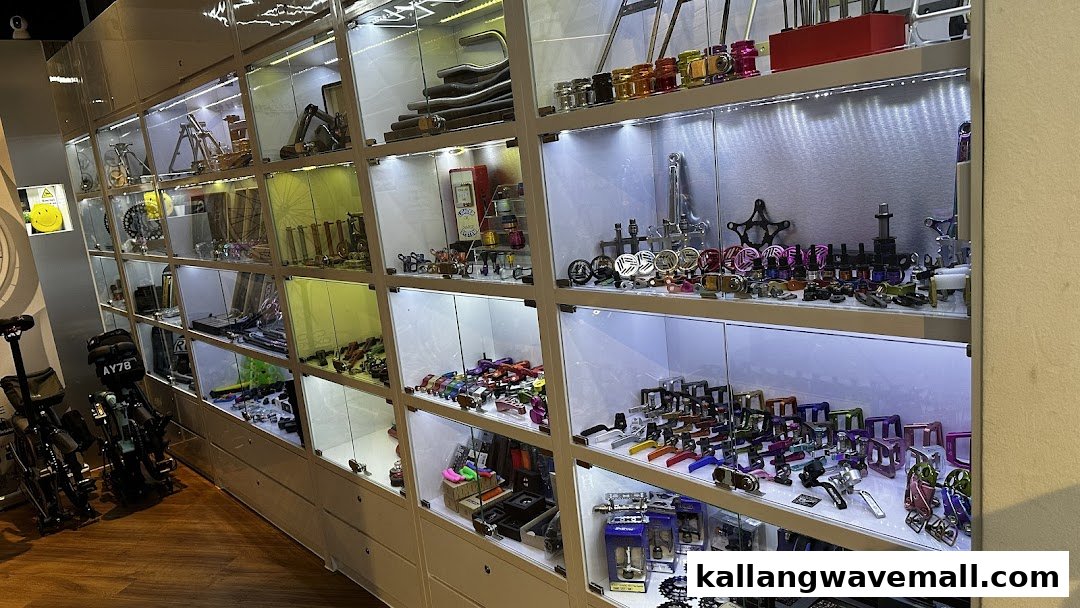 Brightly lit display cases showcase a wide array of colorful and specialized bicycle parts and accessories.