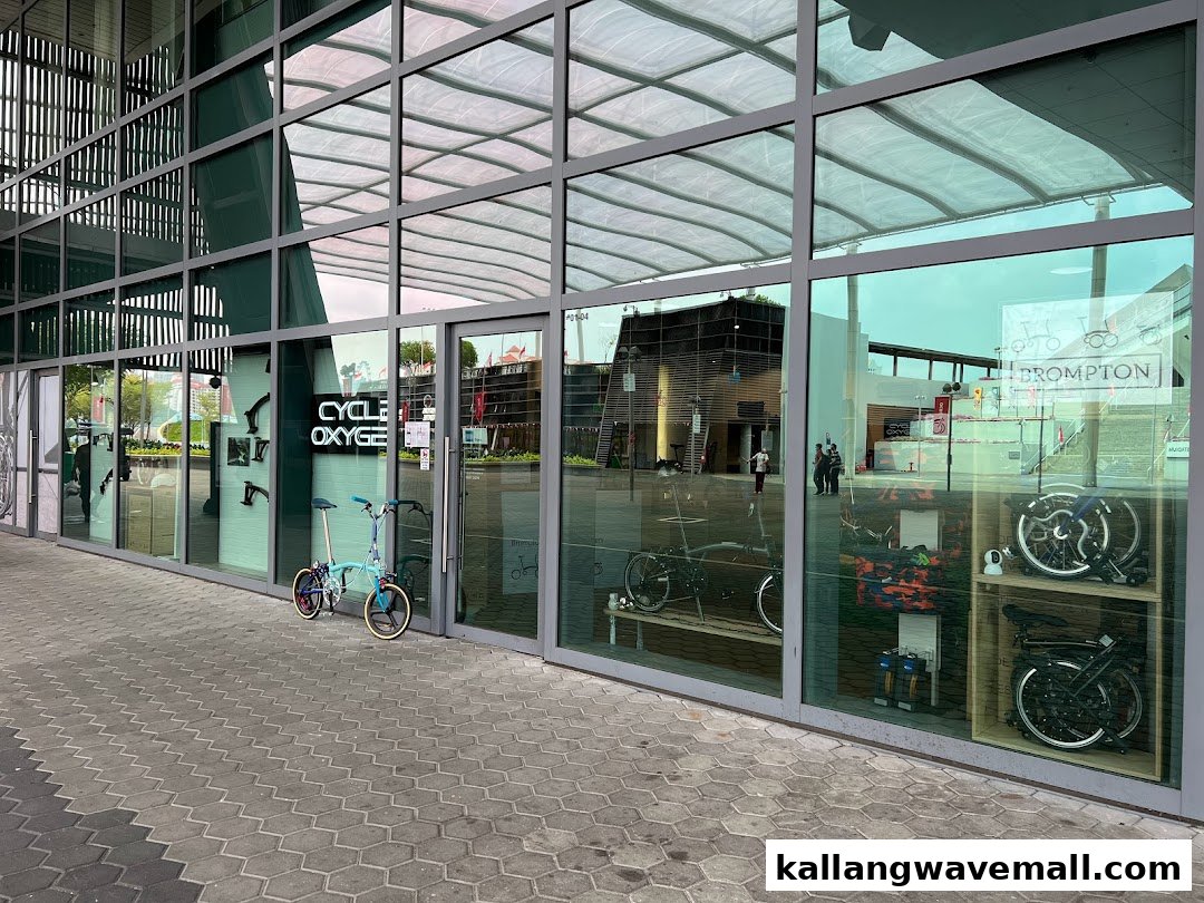 The glass facade of CycleOxygen, a bicycle shop, showcasing various bikes and cycling accessories.