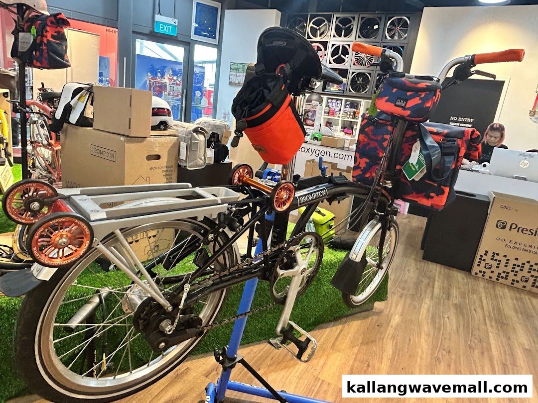 An interior view of CycleOxygen, showcasing a Brompton folding bike and various cycling accessories.