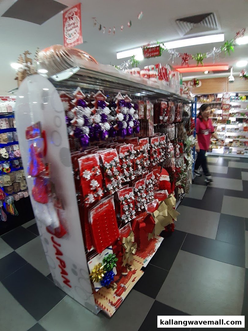An aisle in Daiso featuring a display of Christmas decorations and a shopper.