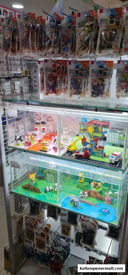 A retail display showcasing various Petit Block mini-building sets and their assembled models at Daiso.