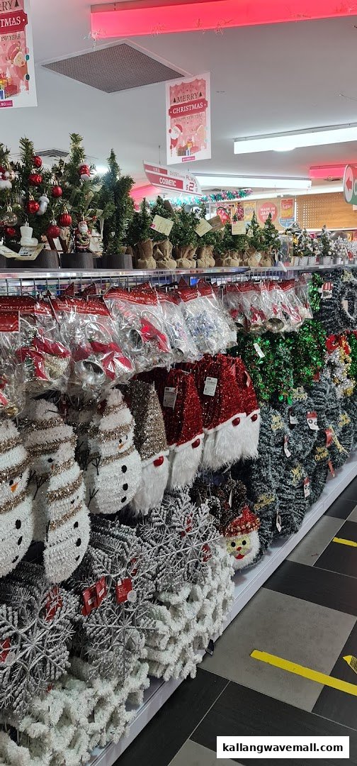 A retail store aisle showcasing a wide array of Christmas decorations, including trees, ornaments, and festive figures.