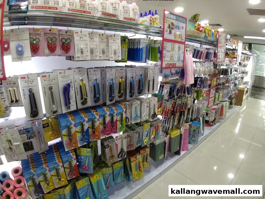 An interior view of a Daiso store aisle, showcasing a wide array of stationery and craft supplies.