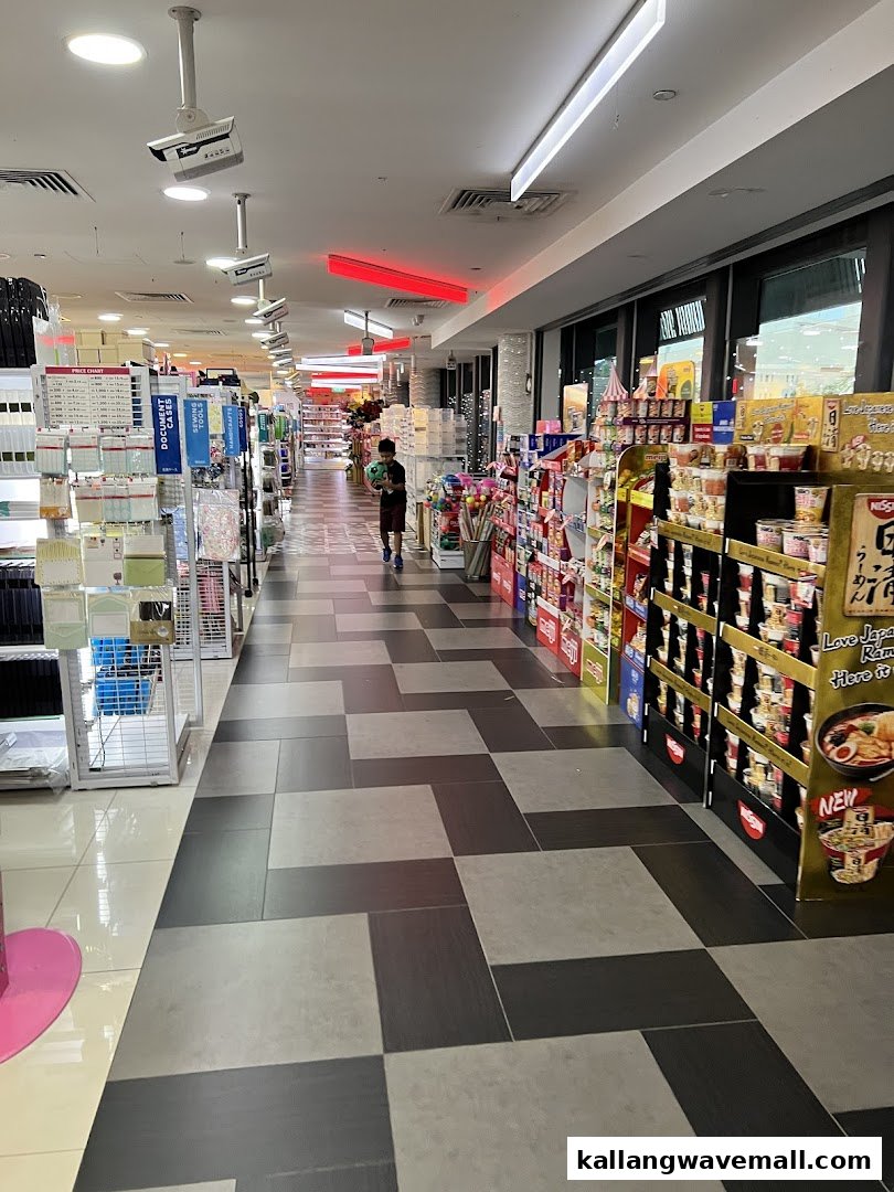 An interior view of Daiso, showcasing a wide aisle filled with diverse products and a customer browsing.