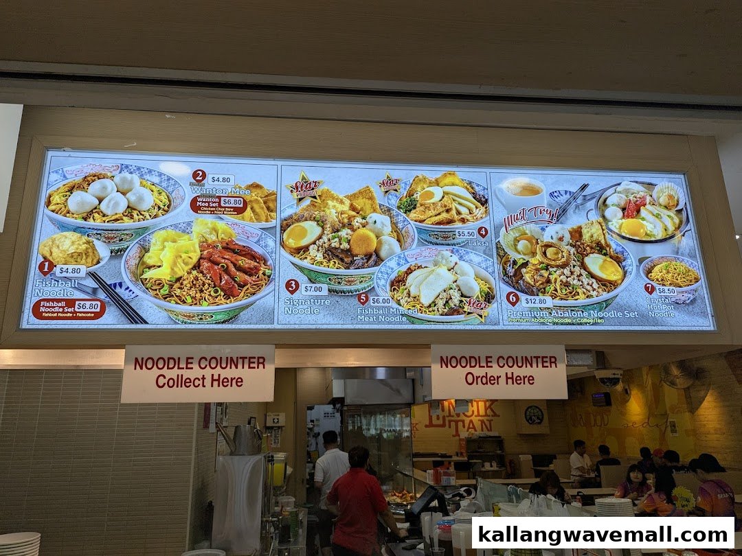 A digital menu board displaying various noodle dishes and sets at Encik Tan.