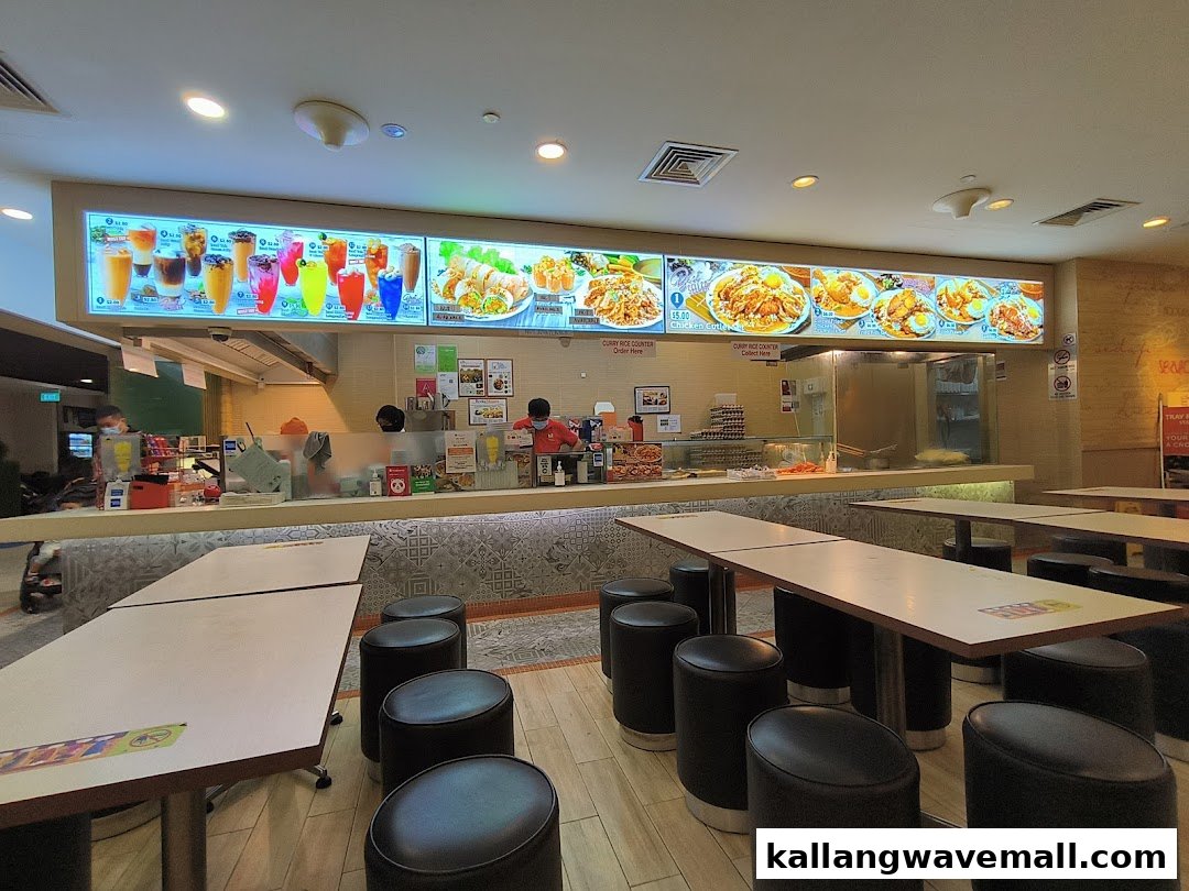 Interior view of Encik Tan, showing the food counter, digital menu boards, and dining area.