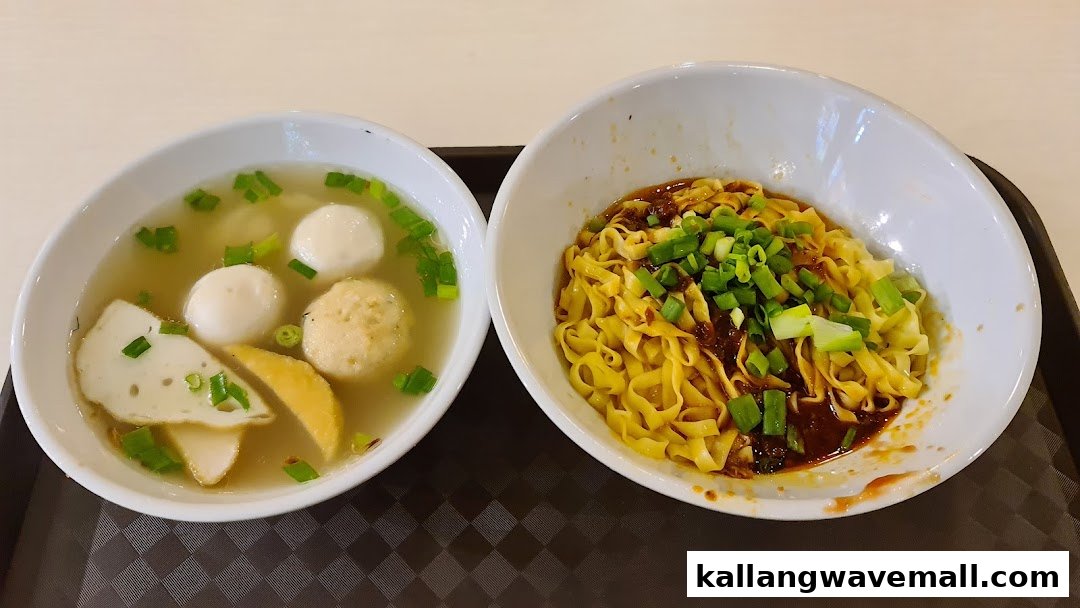 Two bowls of Singaporean hawker food: dry noodles and fishball soup.