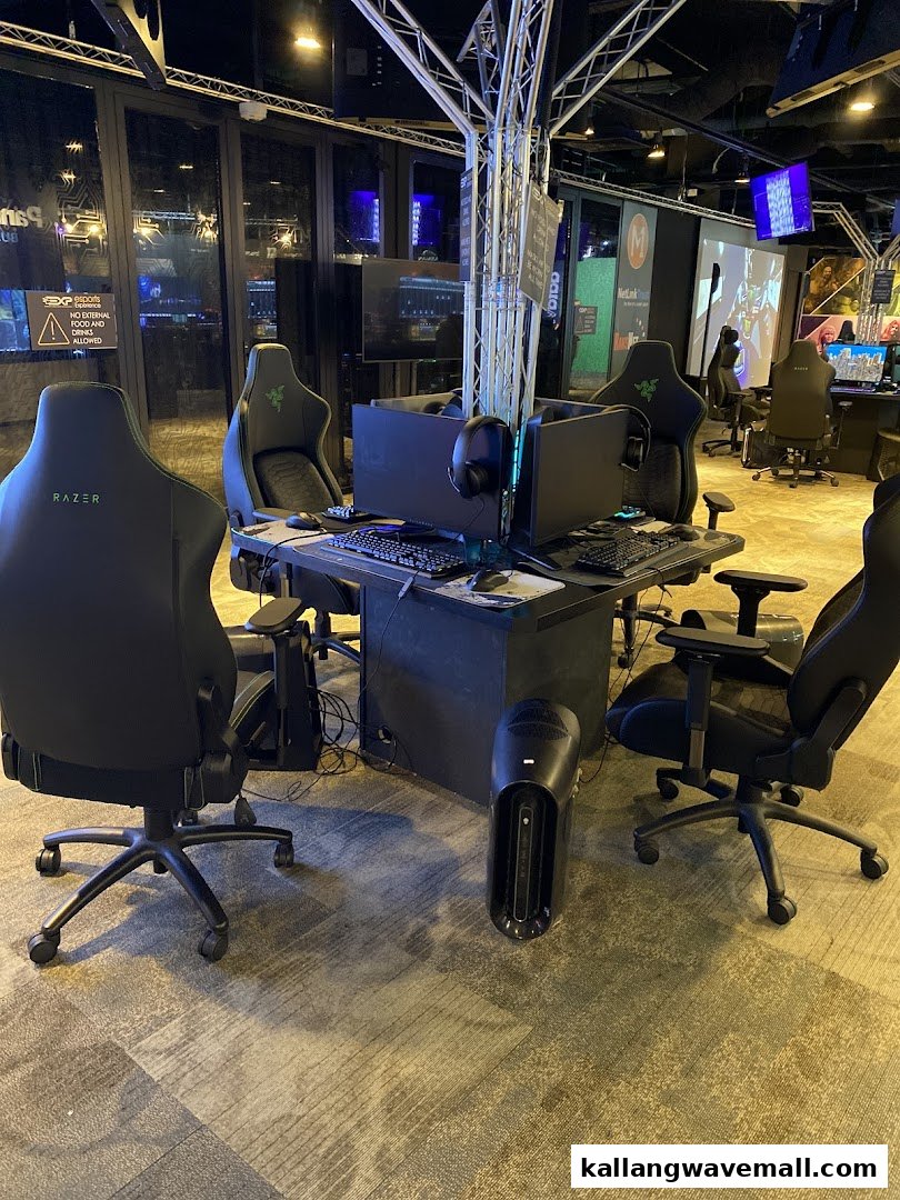 A multi-station gaming setup with high-performance PCs and Razer gaming chairs in an esports center.