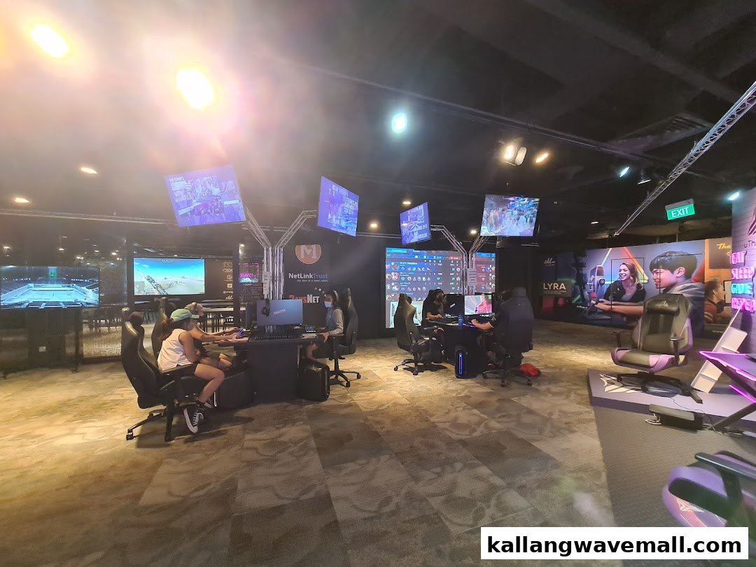 People are actively engaged in gaming at multiple stations within a modern esports experience center.