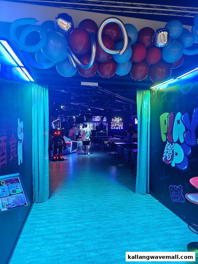 A vibrant, neon-lit entrance to an Esports Experience Center, decorated with balloons, leading into a gaming area.