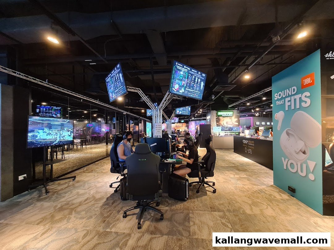 People are engaged in gaming at an esports experience center, surrounded by multiple screens and gaming setups.