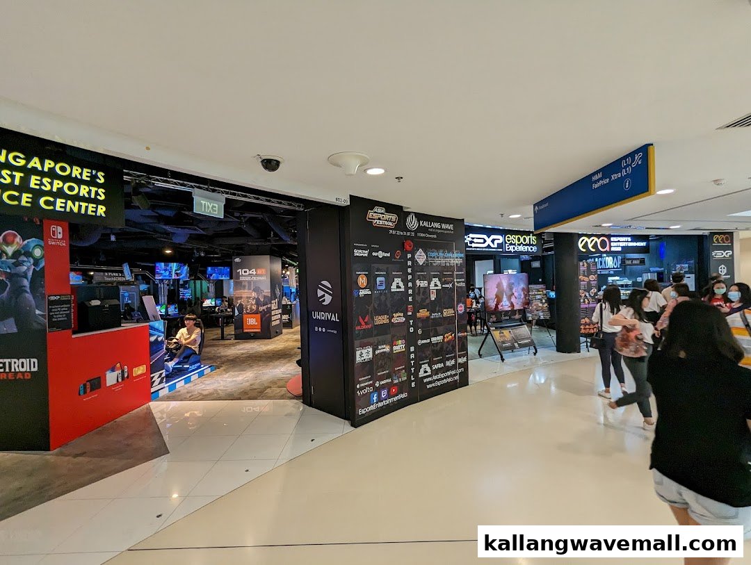 The entrance of an Esports Experience Center in a mall, showcasing gaming setups and promotional displays.