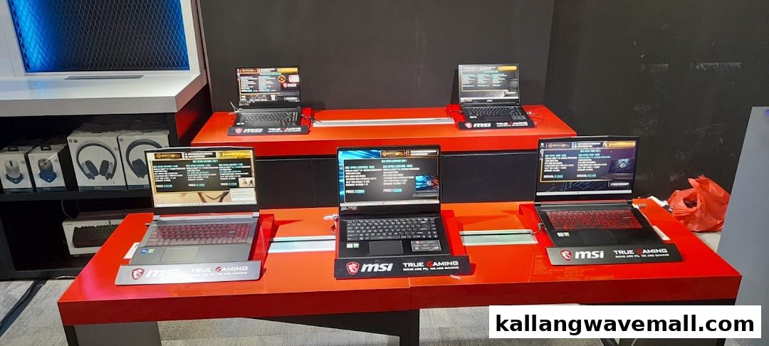 A display of MSI gaming laptops and accessories on red stands in an Esports Experience Center.