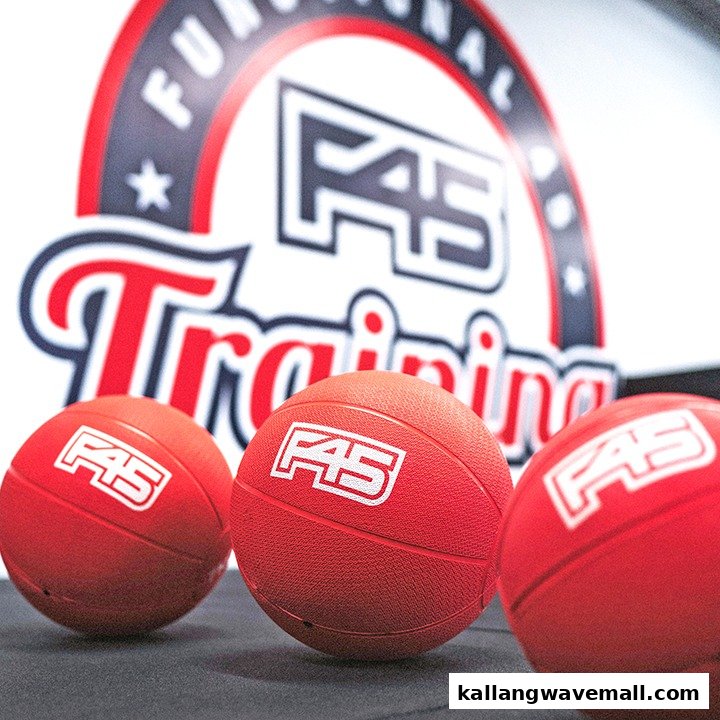 Three red F45 branded training balls with the F45 Functional Training logo in the background.