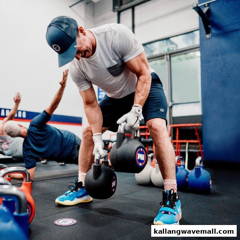A man performs a kettlebell exercise during a high-intensity workout at F45 Training.
