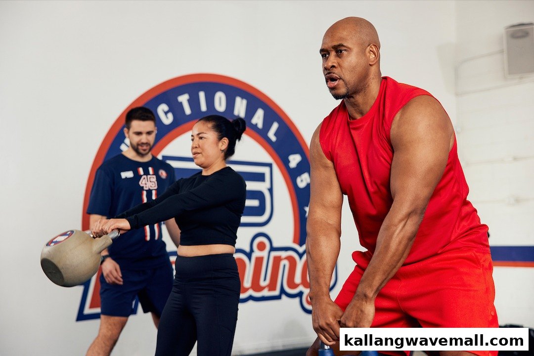 People exercising with weights in an F45 Training gym, focusing on functional fitness.