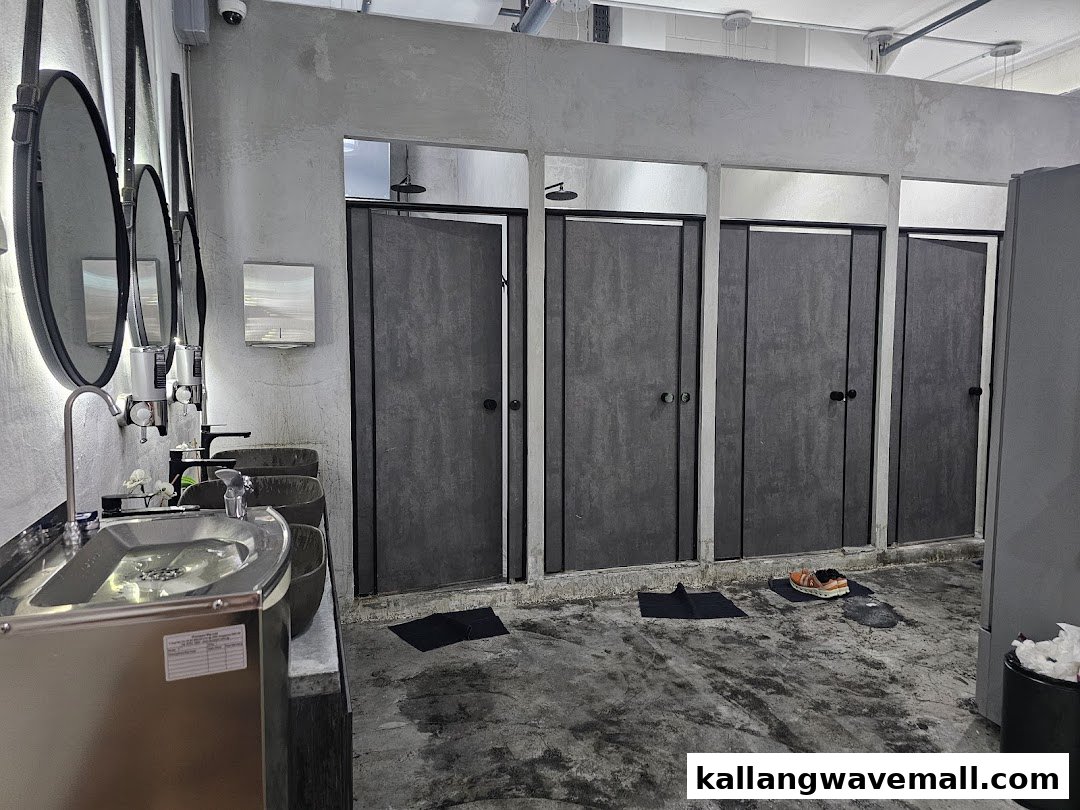 Modern washroom and shower facilities at F45 Training, featuring multiple stalls and sleek sinks.