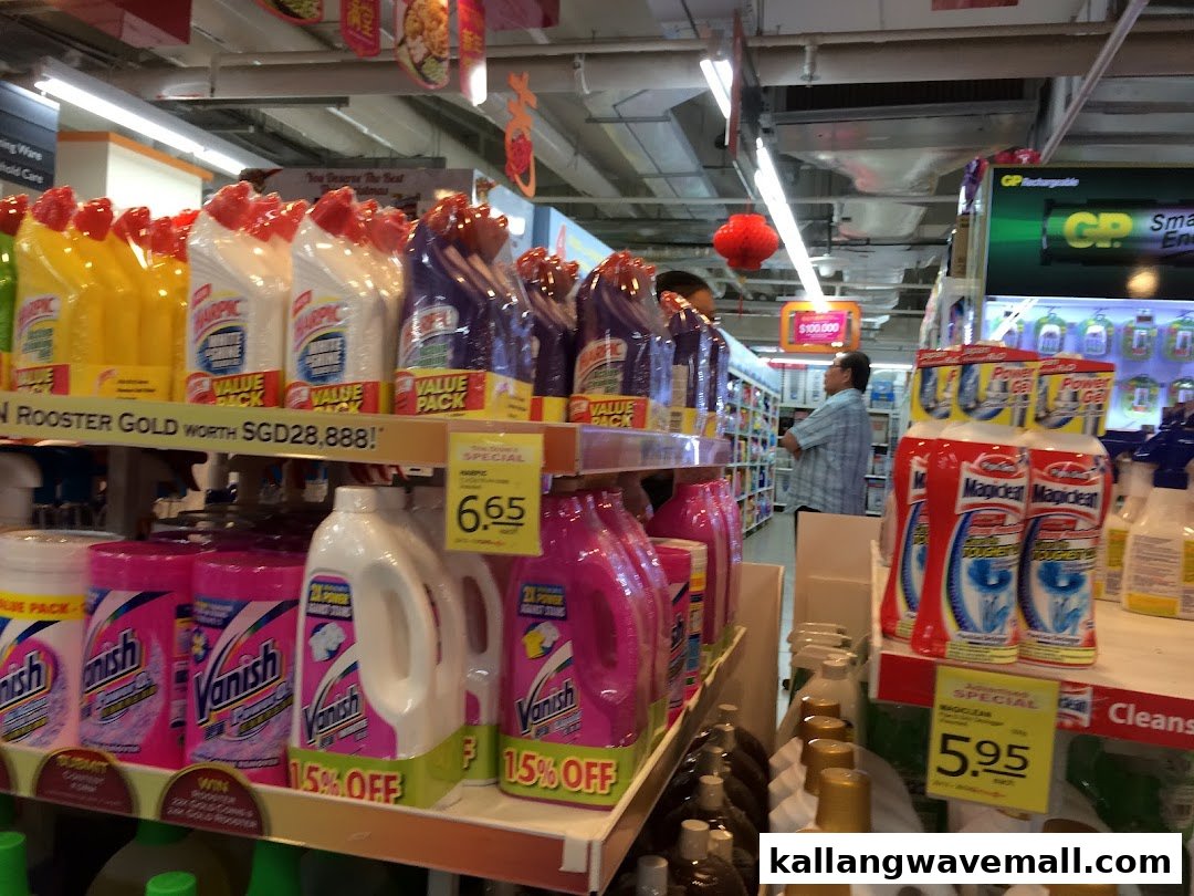 An aisle in FairPrice Xtra featuring cleaning products and a shopper browsing.