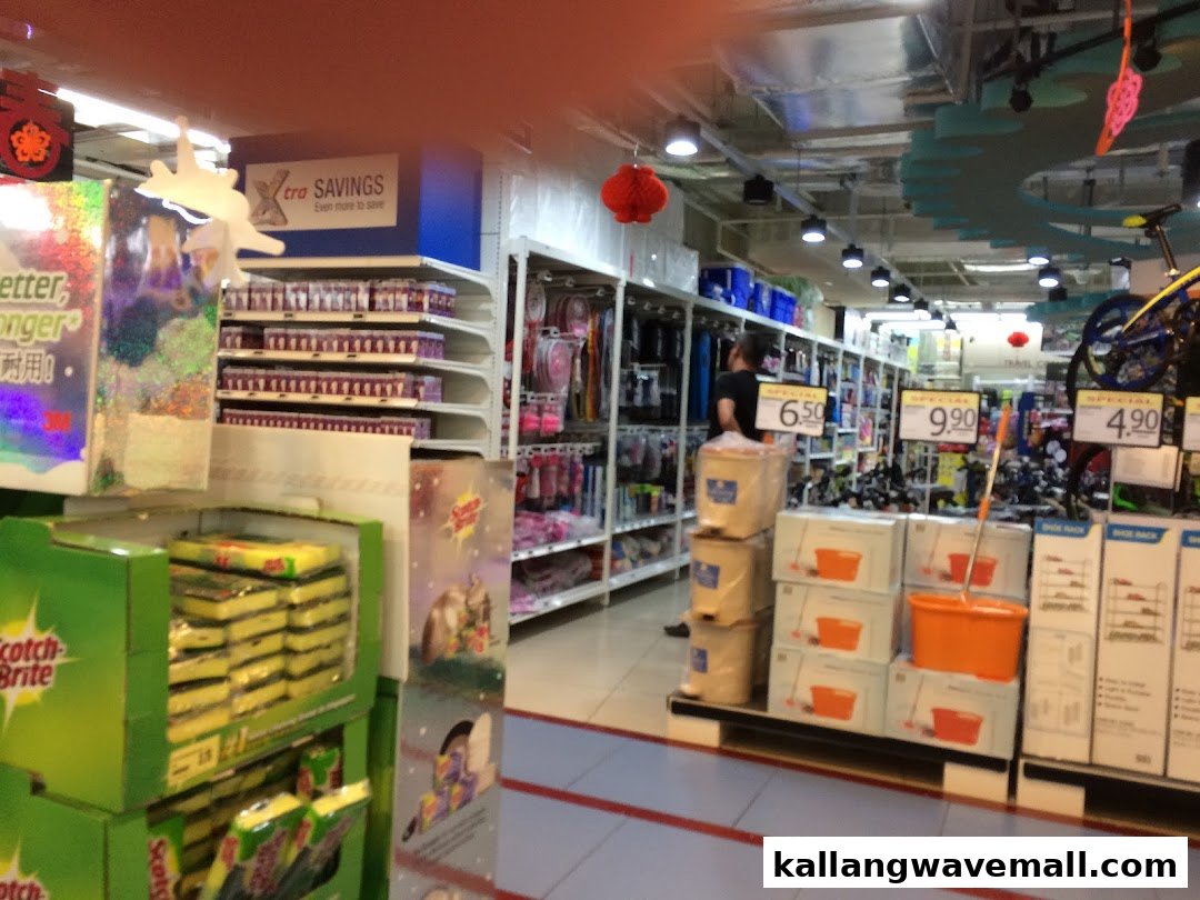 Interior view of FairPrice Xtra, showing aisles stocked with household goods and cleaning supplies.