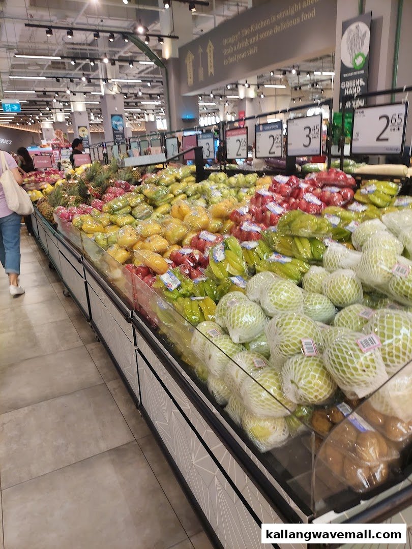 A vibrant display of fresh fruits and vegetables inside FairPrice Xtra supermarket.