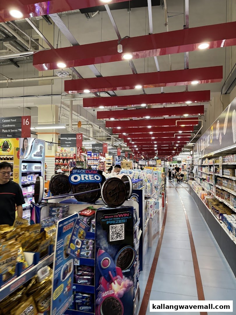 A brightly lit supermarket aisle at FairPrice Xtra, showcasing diverse groceries and an Oreo display.