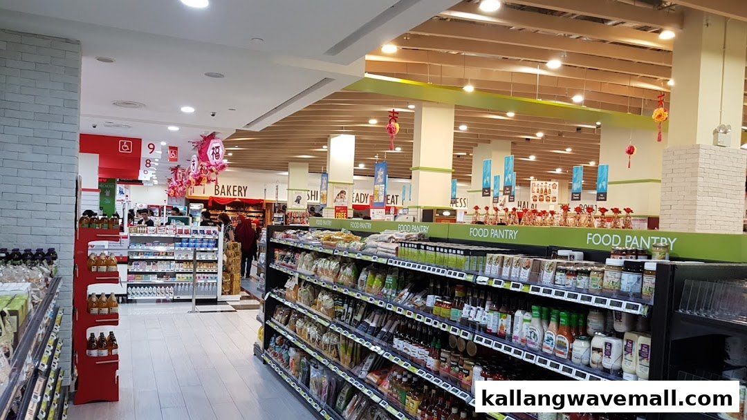 An interior view of FairPrice Xtra, showcasing well-stocked food pantry aisles and festive decorations.