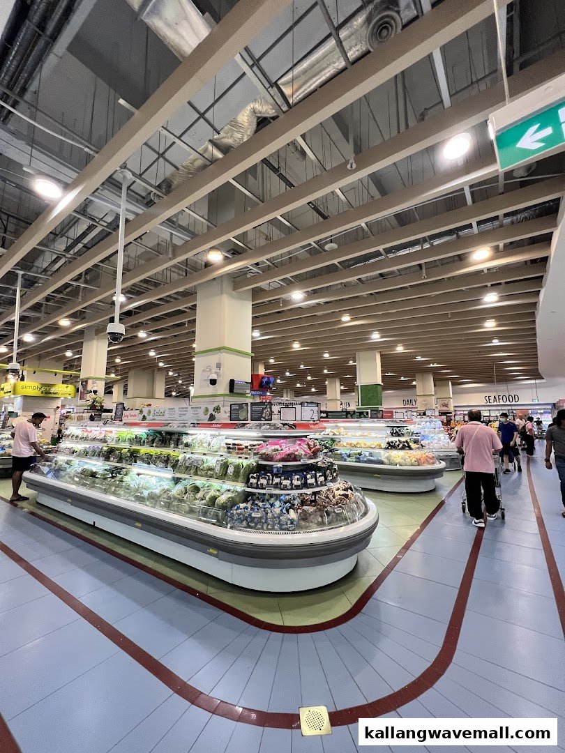 Spacious interior of FairPrice Xtra supermarket, featuring fresh produce displays and shoppers.