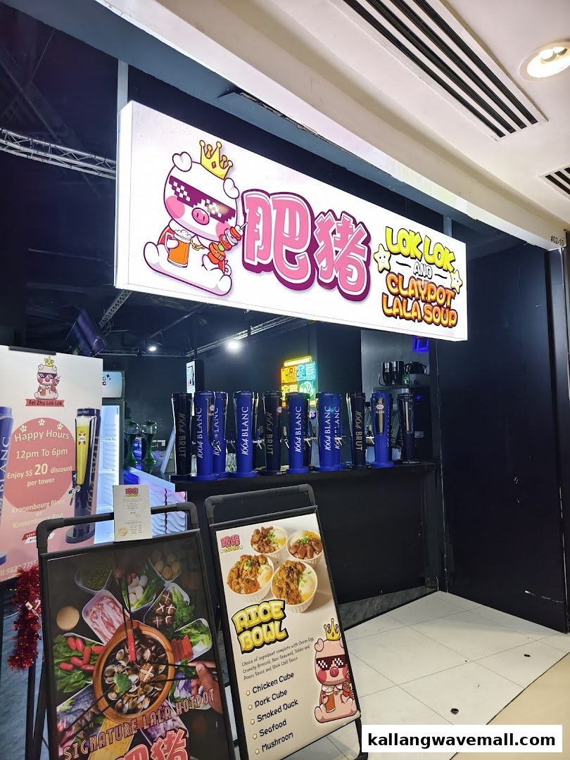 The illuminated storefront of Fei Zhu Lok Lok, featuring its pig mascot, promotional stands, and beer taps.