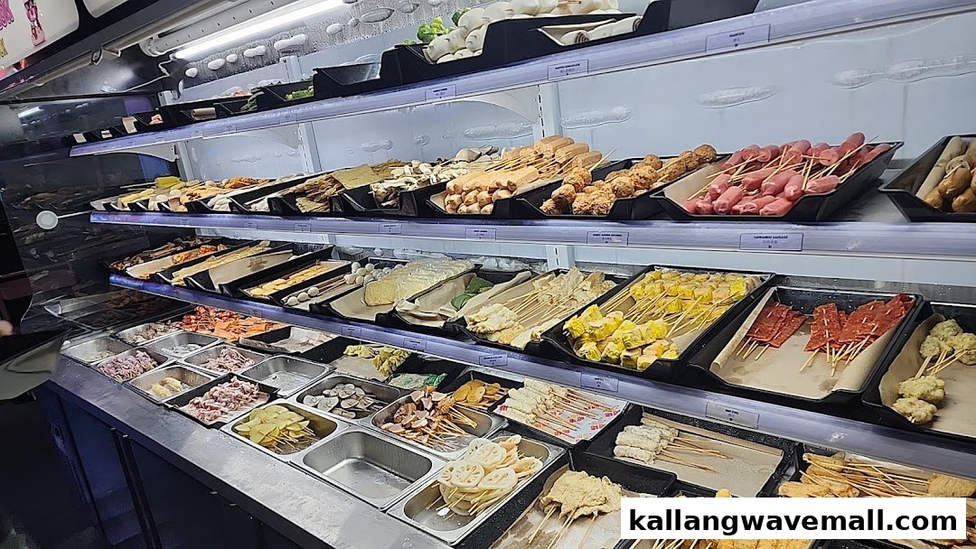 A wide selection of fresh hotpot ingredients, including meats, vegetables, and skewers, displayed in a refrigerated case.