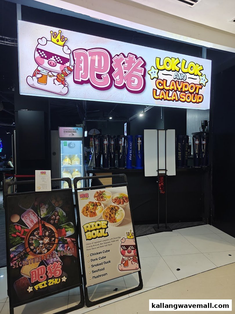 The vibrant entrance of Fei Zhu Lok Lok Claypot Lala Hotpot Restaurant, showcasing its signage and promotional displays.