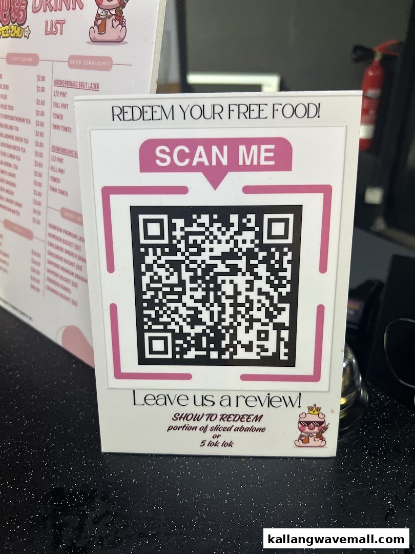 A promotional display with a QR code for free food redemption and a partial drink menu.