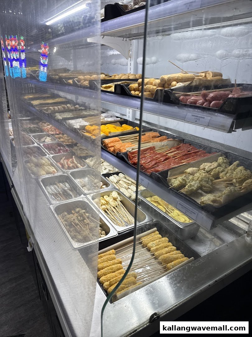 A refrigerated display case showcasing a wide variety of fresh ingredients for hotpot or skewers.
