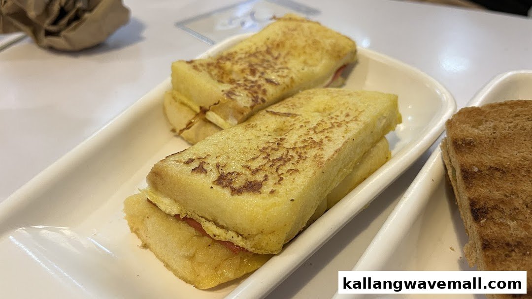 Two servings of French toast and one serving of regular toast on white plates.