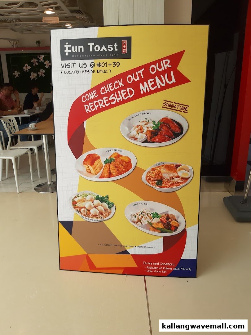 A vibrant standee showcasing Fun Toast's refreshed menu with popular dishes like Laksa and Soya Sauce Chicken.