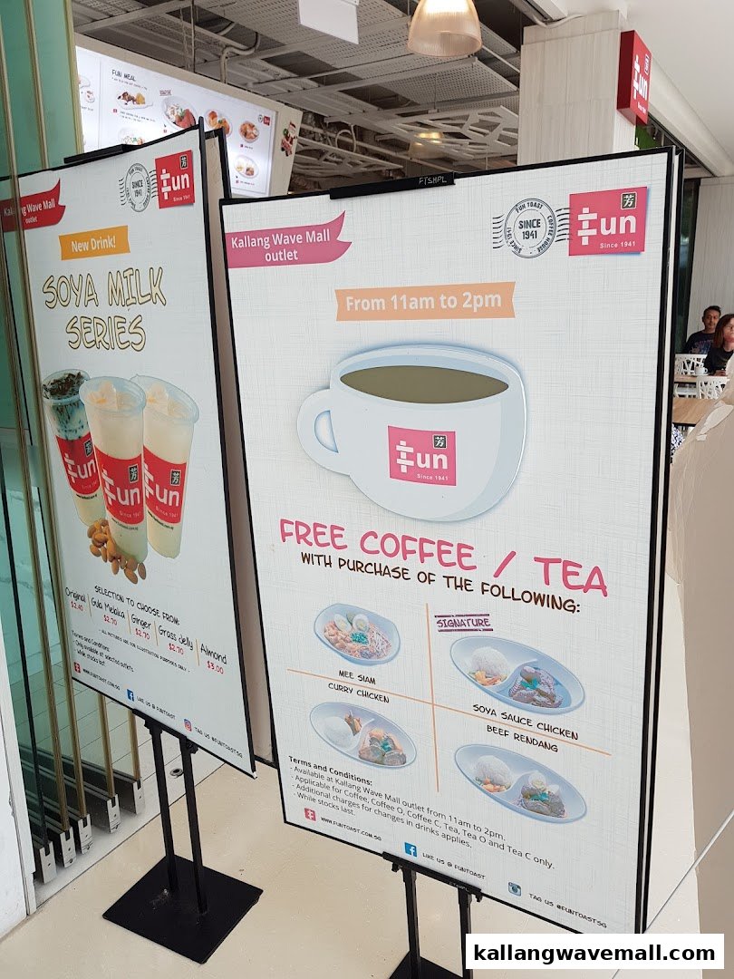 Two promotional standees outside Fun Toast, showcasing new soya milk drinks and a free coffee/tea meal deal.