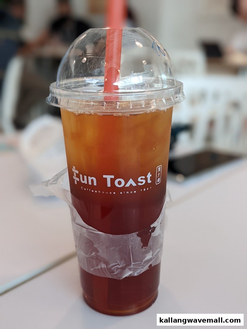 A refreshing iced tea drink from Fun Toast with a red straw, showcasing the brand logo.