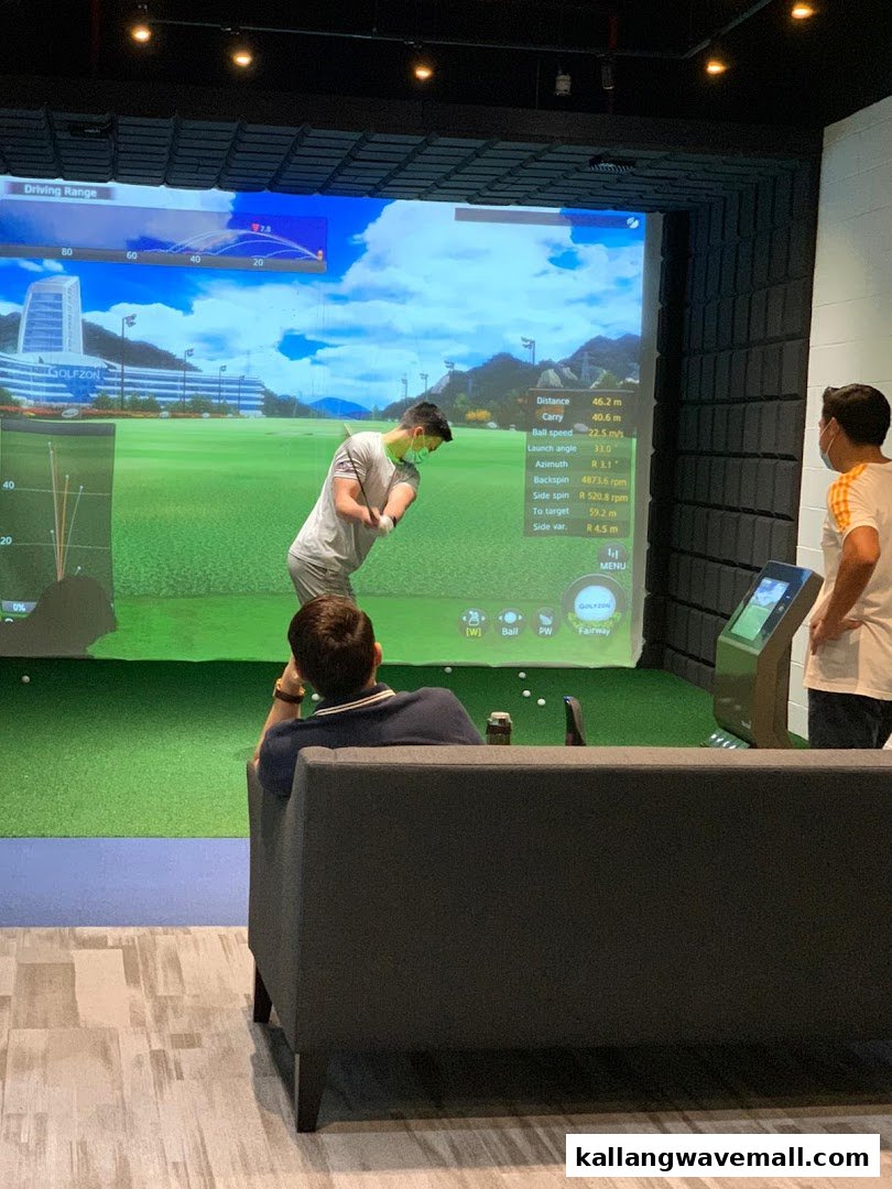 People enjoying an indoor golf simulator experience at Golfwav.