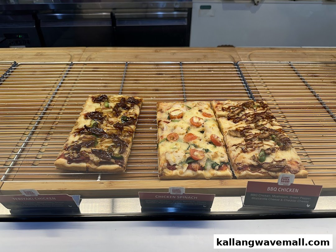 Three rectangular pizza slices with various toppings displayed on a rack with descriptive labels.