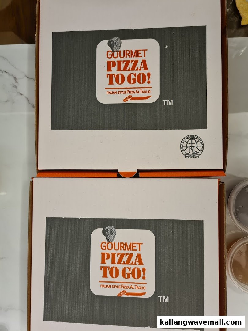 Two pizza boxes from 'Gourmet Pizza To Go!' featuring their distinctive branding.