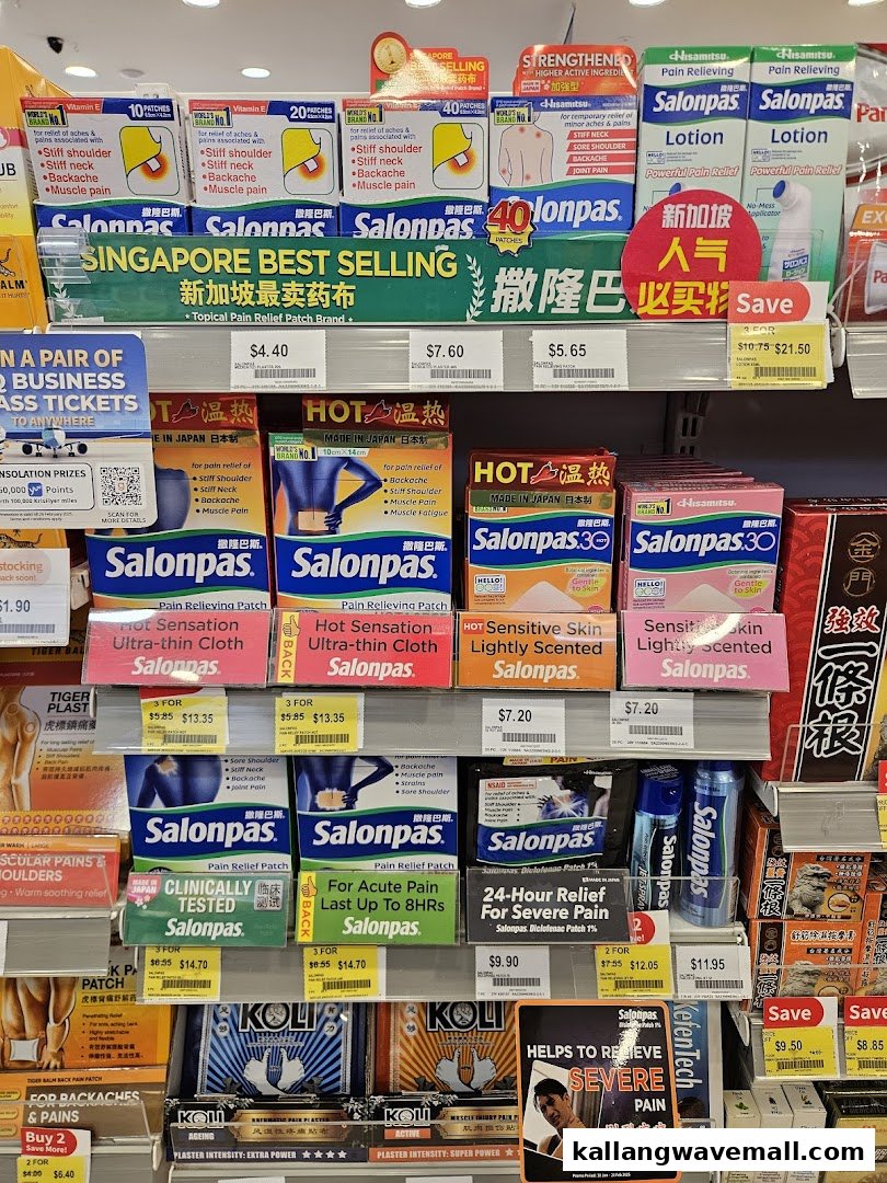 A retail shelf displaying a wide range of Salonpas pain relief patches and lotions.