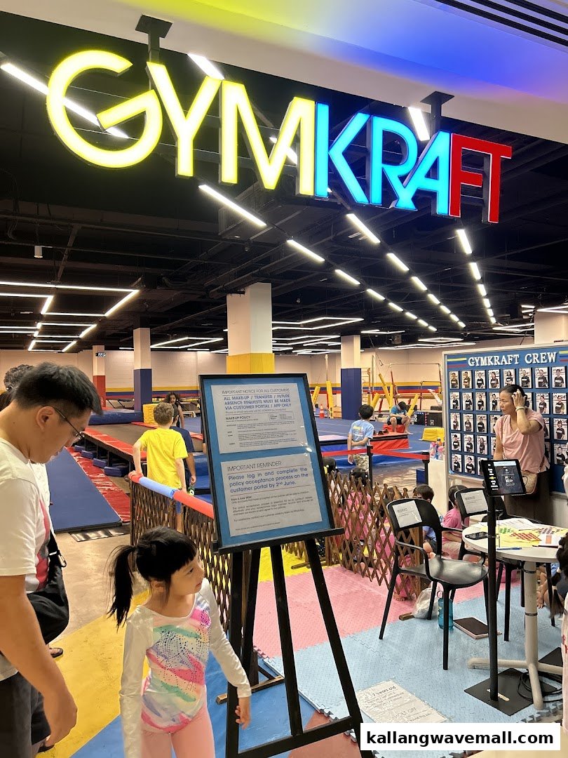 Children and adults engage in activities within the vibrant GymKraft fitness and gymnastics center.